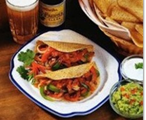 Casual Mexican dining room with simple tables.
